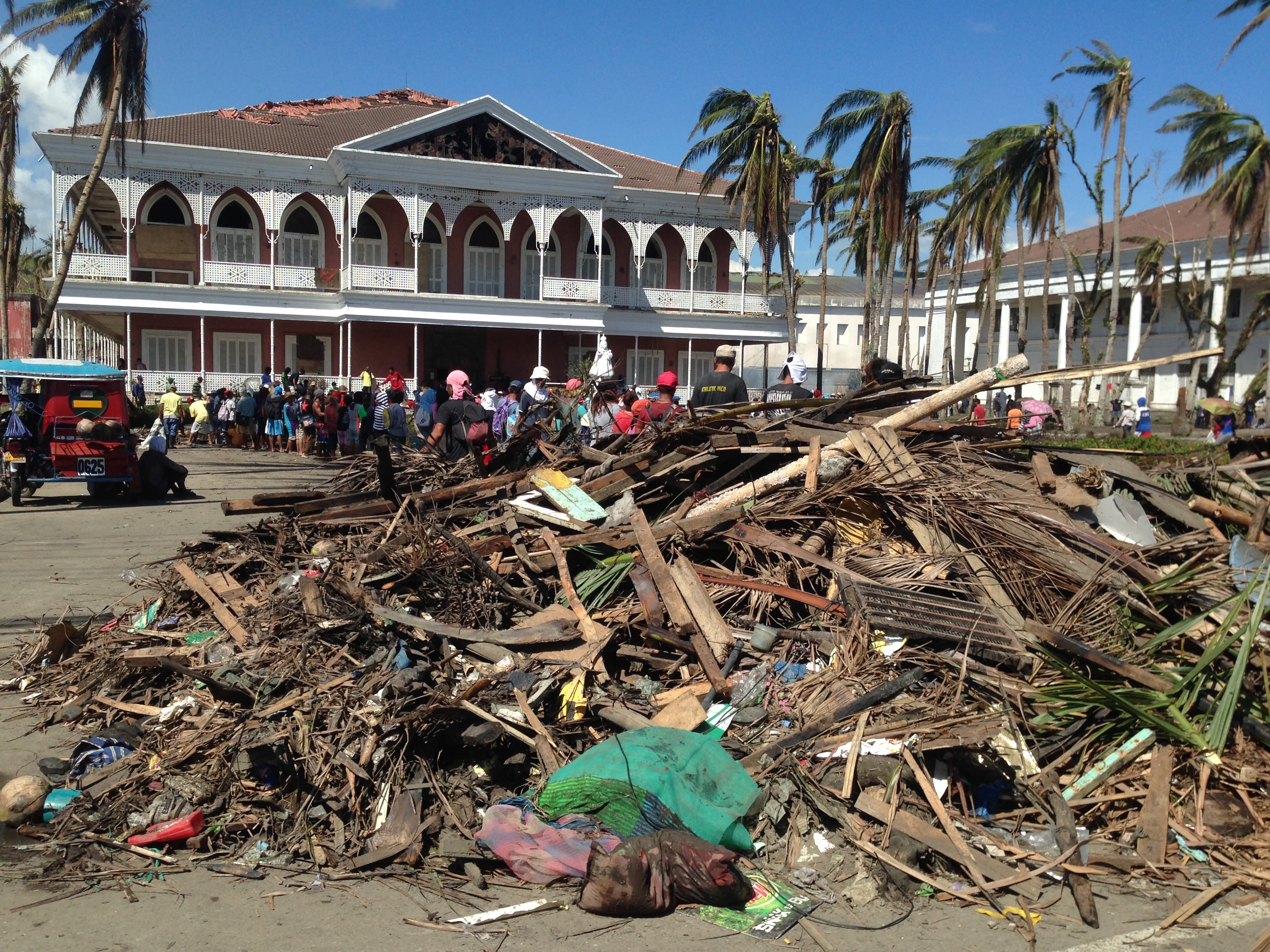A displaced resident pictured next to what was left of her neighbourhood. By Makoi Popioco, November 2013