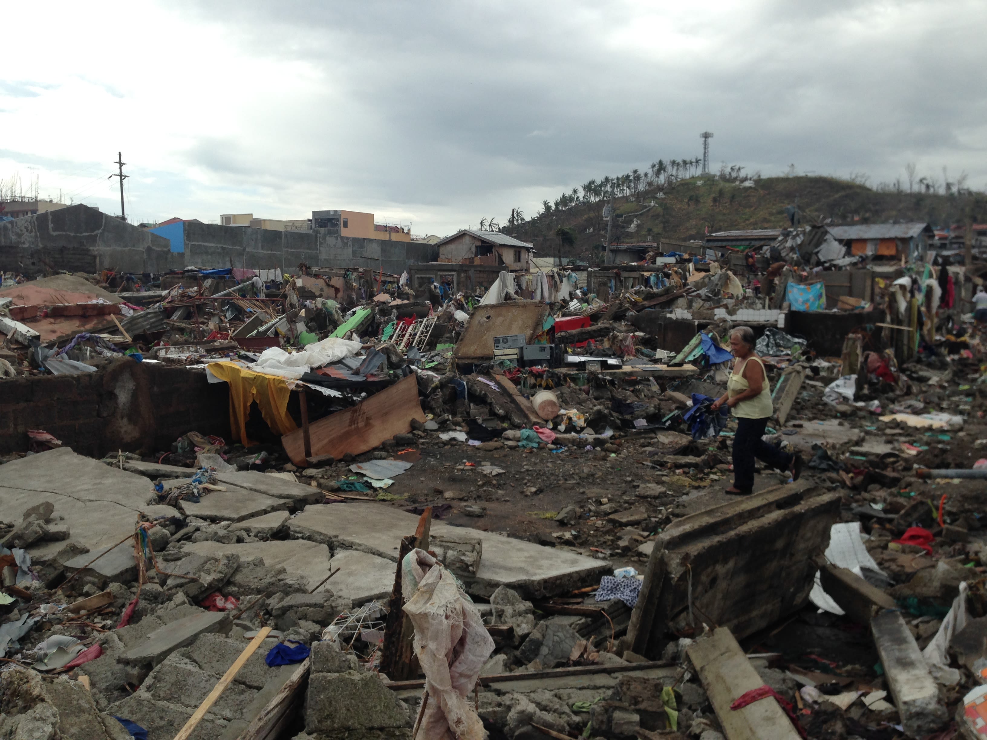 A resident walks through a portion of her community that was completely annihilated by Typhoon Yolanda. By Makoi Popioco, November 2013