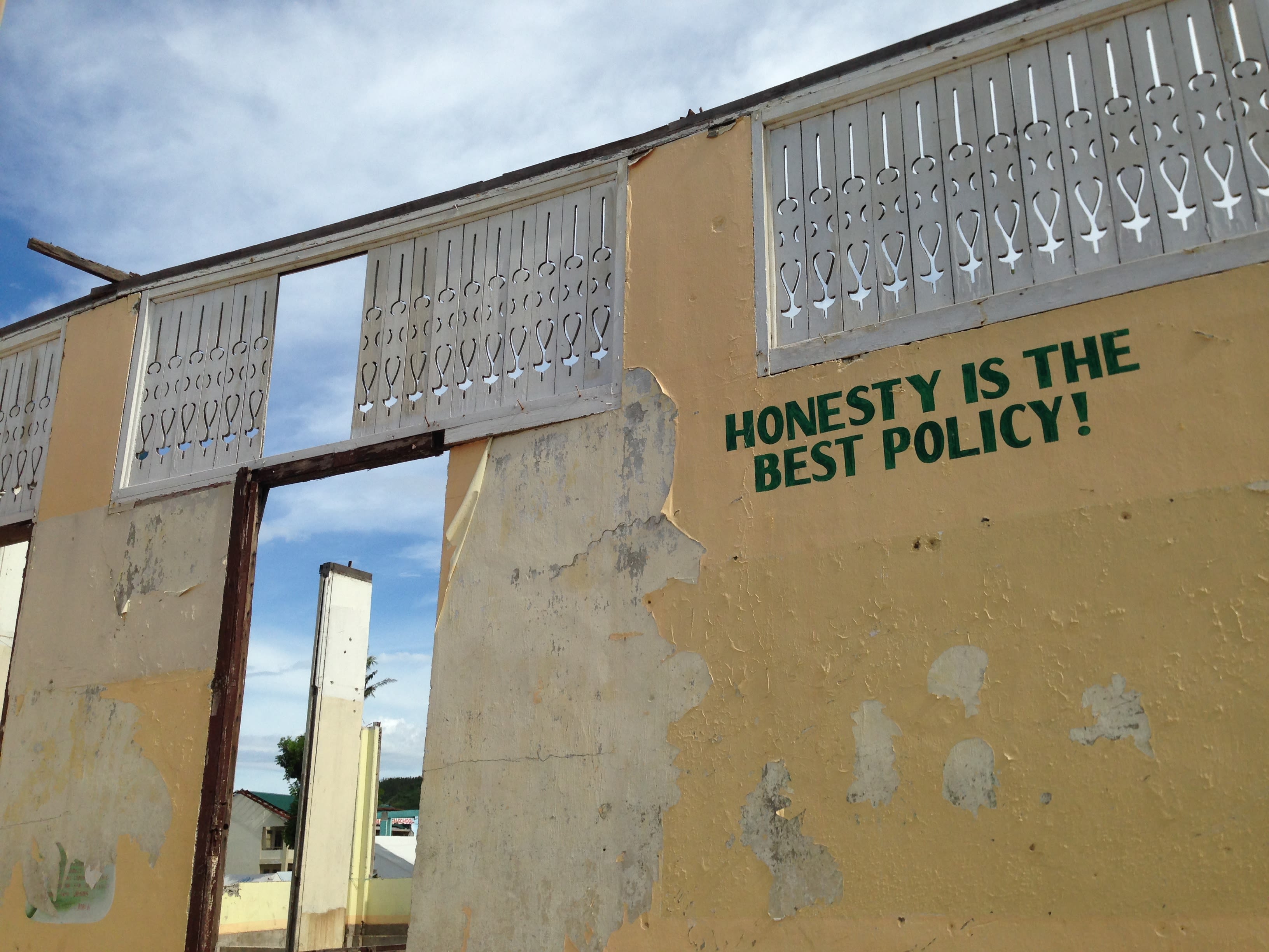 A displaced resident pictured next to what was left of her neighbourhood. By Makoi Popioco, November 2013